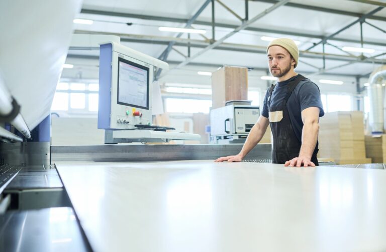 worker-using-cutting-machine-at-factory-2022-05-19-16-52-24-utc